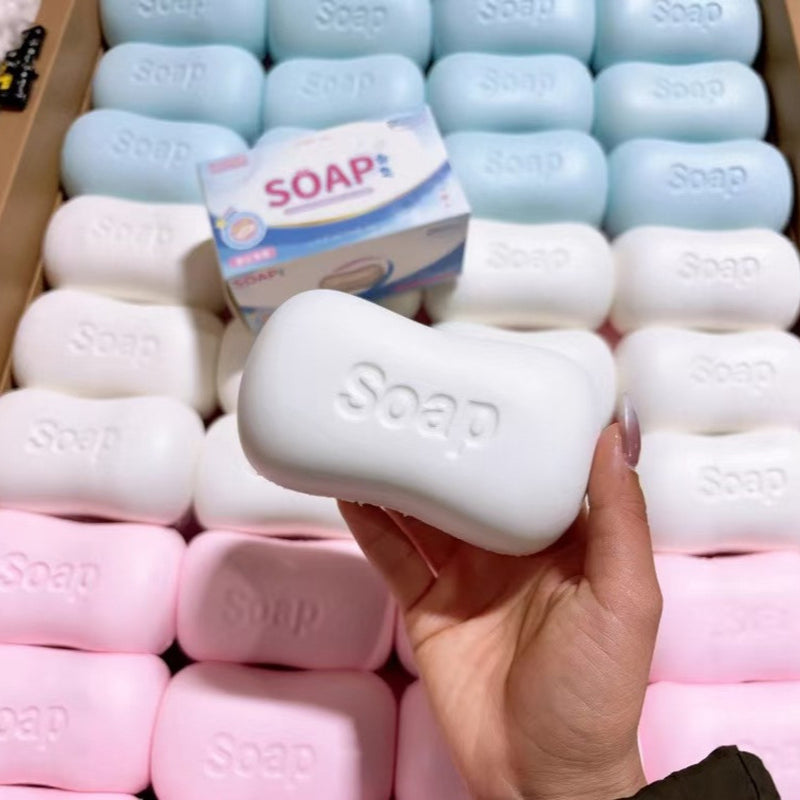 Soap-shaped toy being compressed in a hand